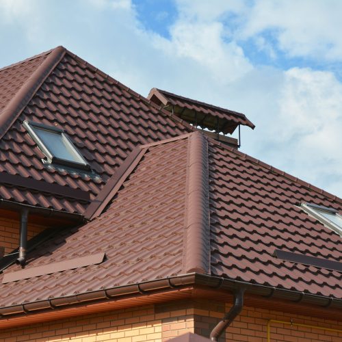 Attic skylights, gutter system, roof windows and roof protection New roofing construction with attic skylights, rain gutter system, roof windows and roof protection from snow board, snow guard exterior.